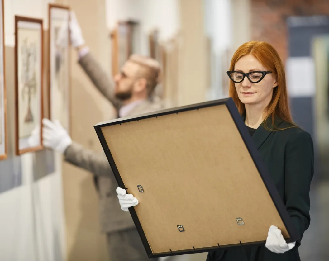 art-manager-standing-with-painting-2025-02-11-15-38-32-utc